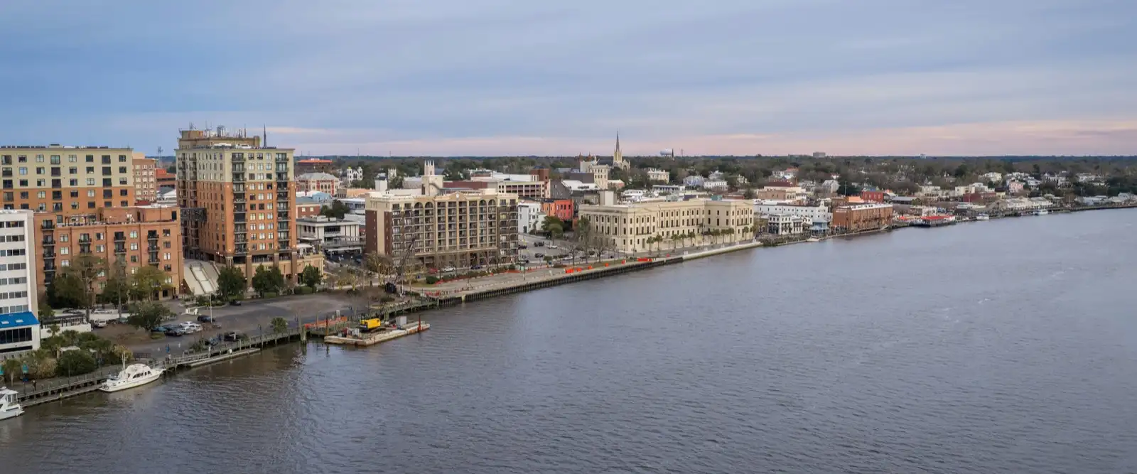 The Cape Fear River curving past the downtown Wilmington, North Carolina waterfront at dusk.